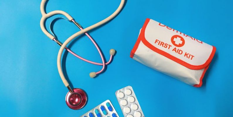 First Aid Kit - a bag of pills, a stethoscope, and a first aid kit